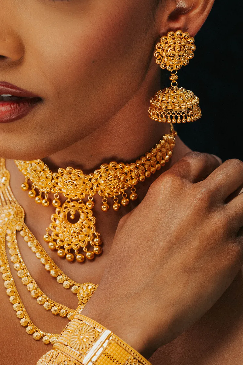Model wearing a 22k gold choker and jhumka earrings, Sonei Jewellers Surrey