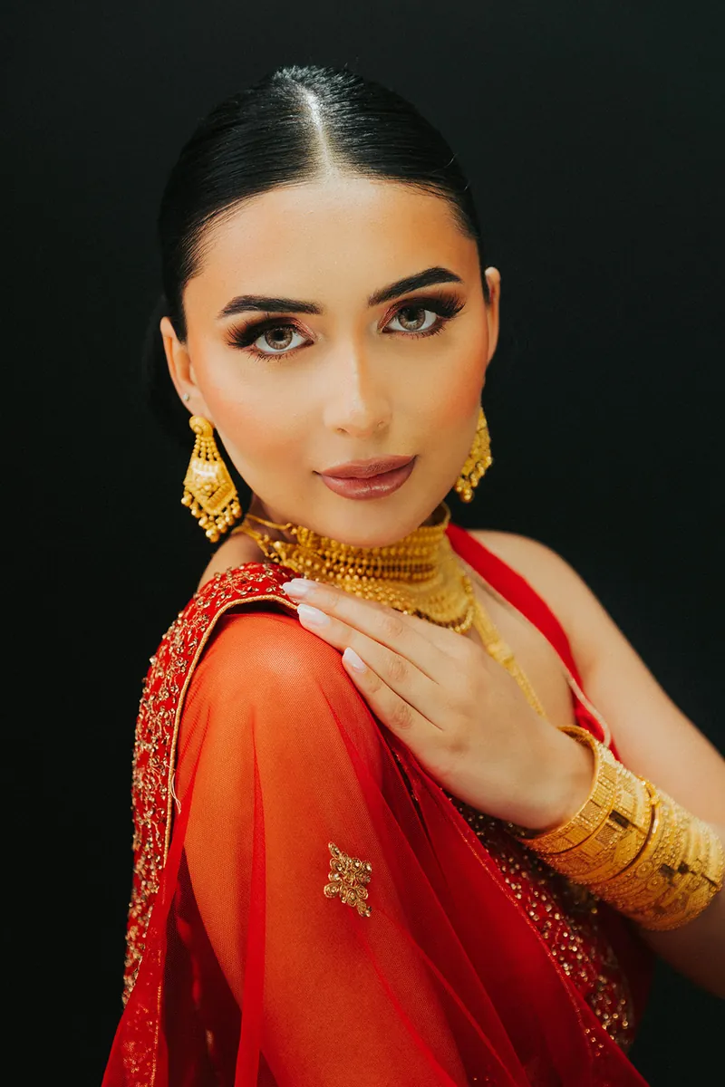 Model with her hair in a bun wearing a 22k gold choker and necklace, Sonei Jewellers Surrey