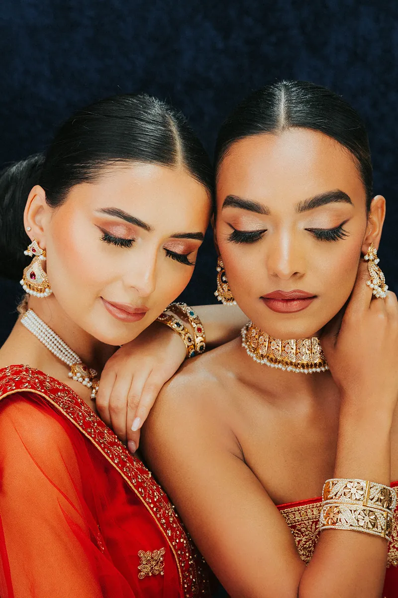 Two models wearing kundan and pearl jewellery, Sonei Jewellers Surrey