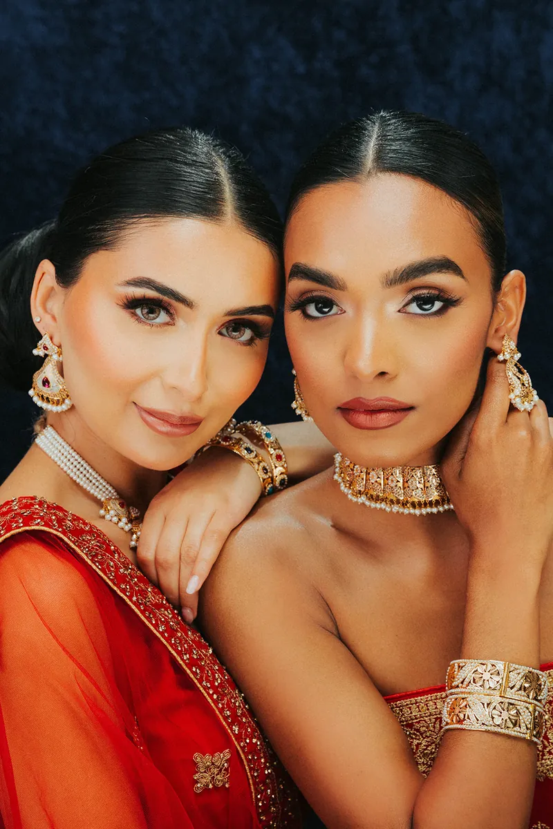 Two models wearing kundan chokers and bangles, Sonei Jewellers Surrey